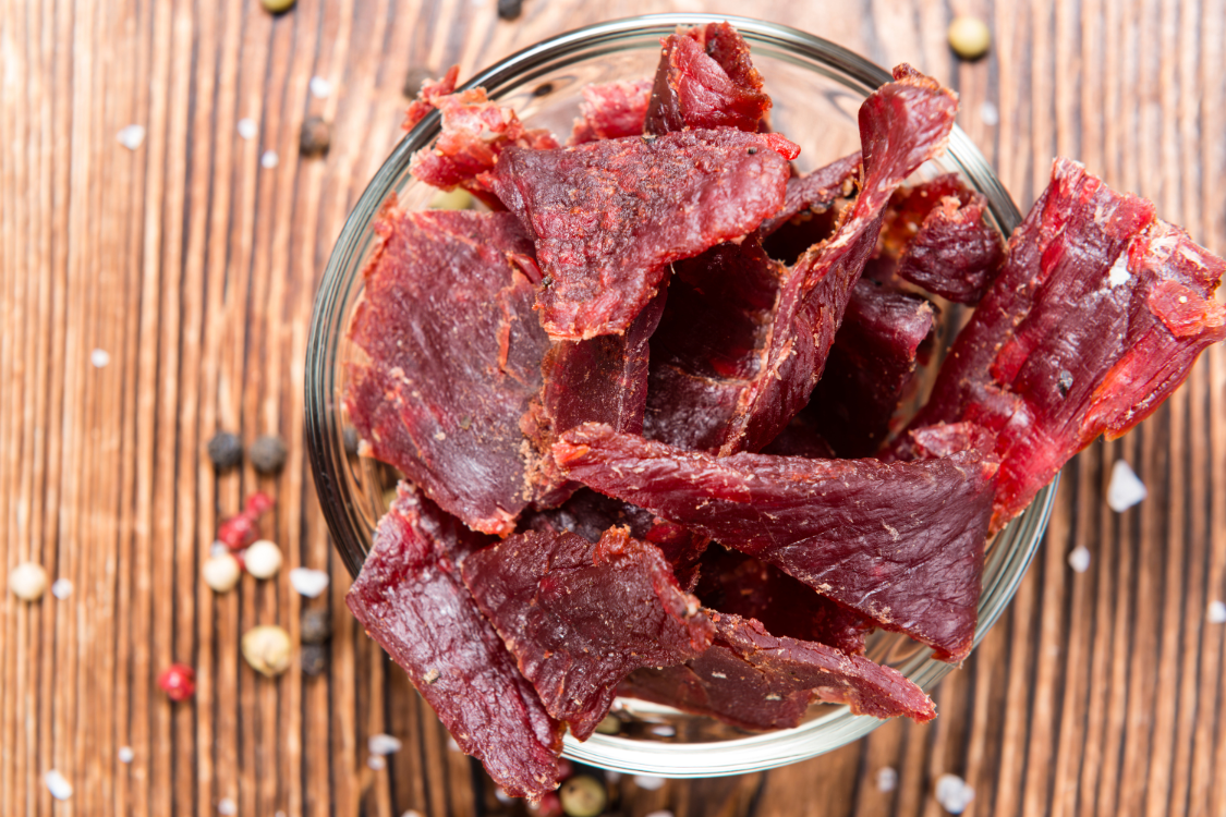 Beef jerky on a glass container.
