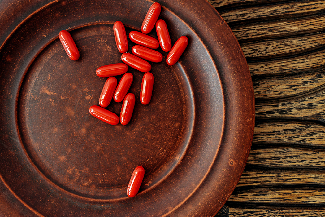 Brown dish with orange supplements.