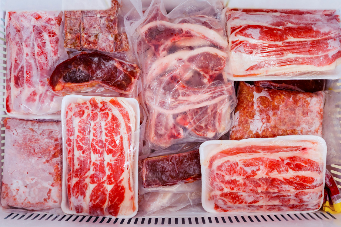 Vacuum-sealed frozen beef and jerky packs stored in a home freezer