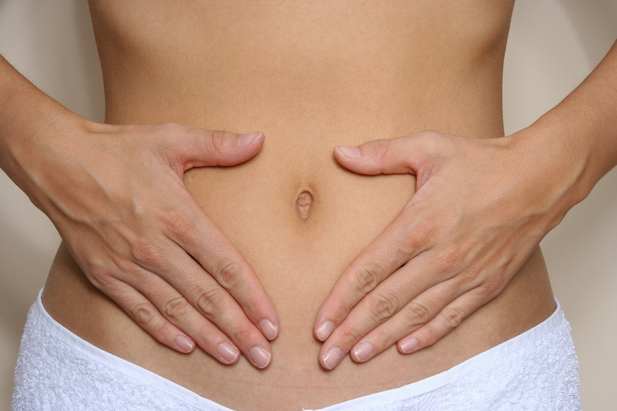 Woman holding her stomach.