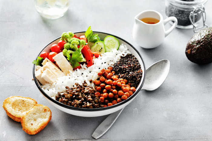 A plate with a range of protein-rich foods, including plant-based proteins, dairy, fish, nuts, and legumes.