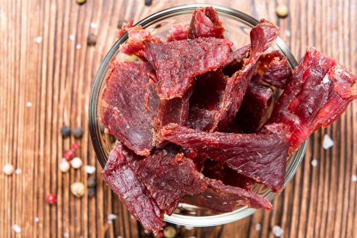 Beef jerky on a glass container.