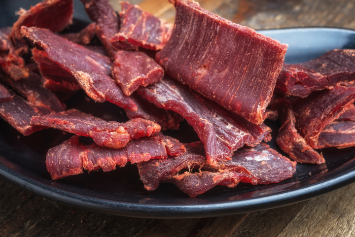 Close up of beef jerky on a plate.