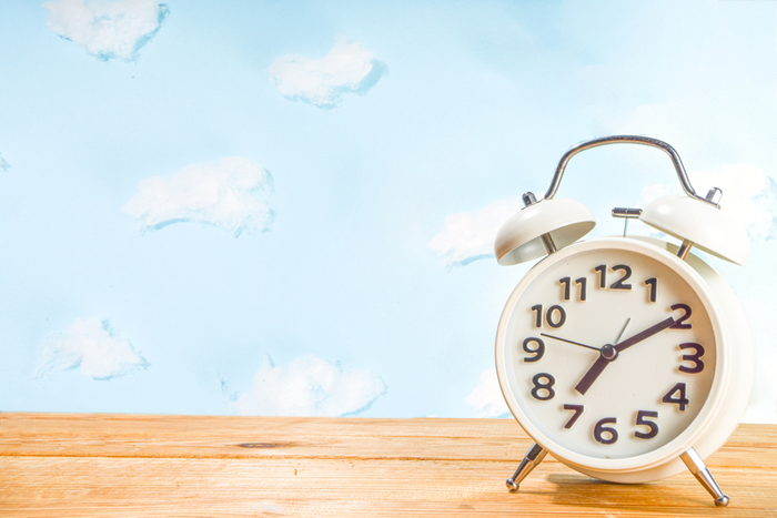An alarm clock on a white background.