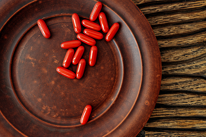 Brown dish with orange supplements.