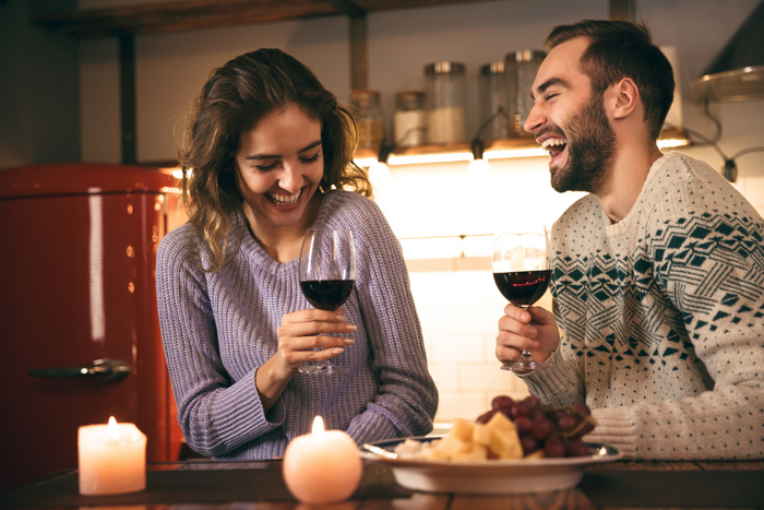 Couple happily drinking wine.