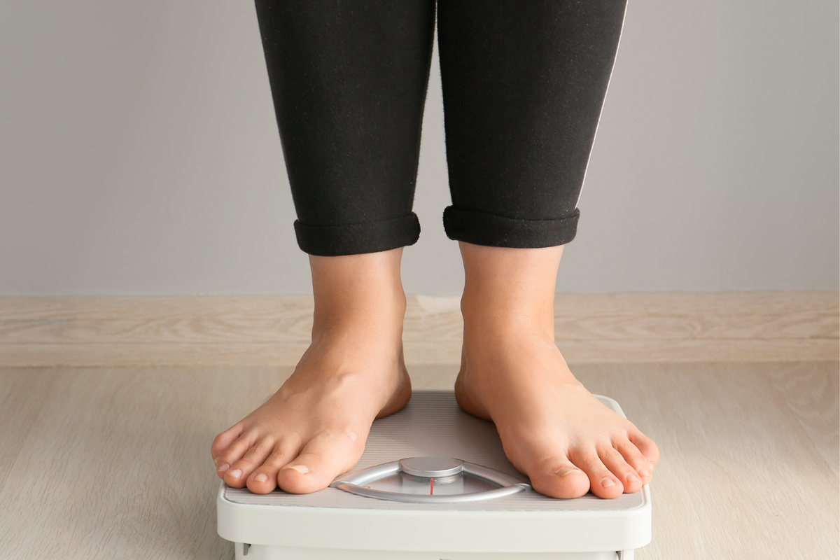 Woman on a weighing scale.