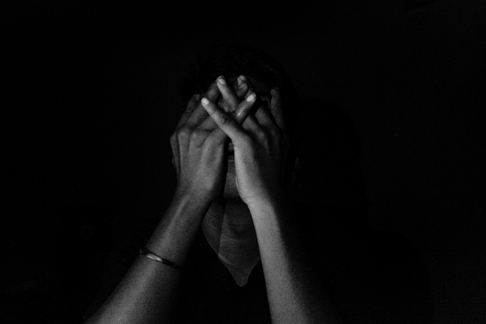 Dark image of person with mental health issues.