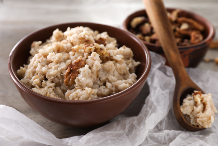 A bowl of oatmeal with walnuts.