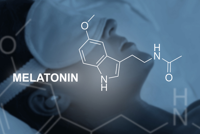 Melatonin molecular structure over a sleeping person with a sleeping mask.