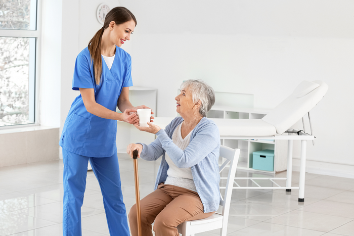 Elderly woman with a healthcare professional.