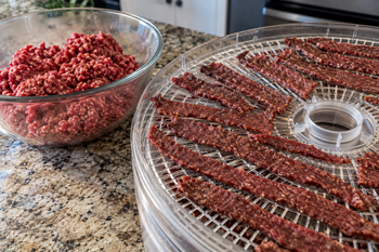 Ground beef jerky strips on dehydrator tray