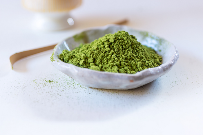 Clumpy, uneven green tea powder indicating low-grade or fake matcha quality