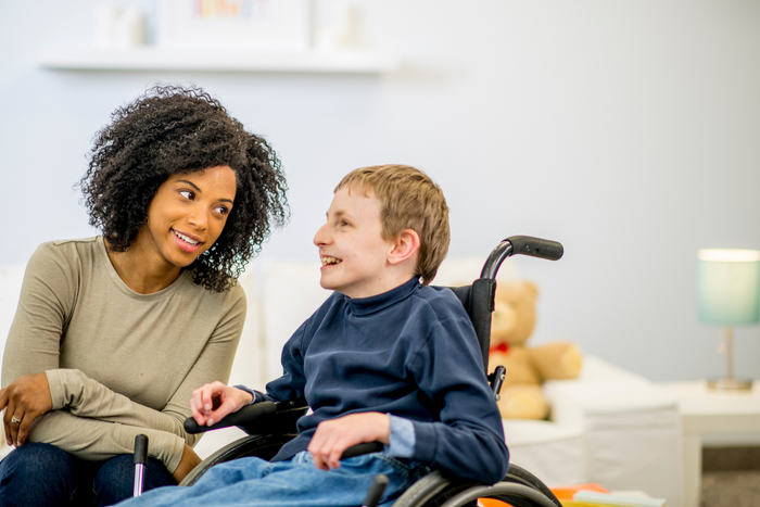 Child with mitochondrial disease and his caregiver.