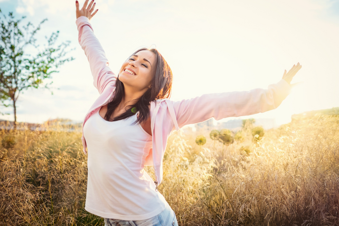 Happy woman with arms outstretched.