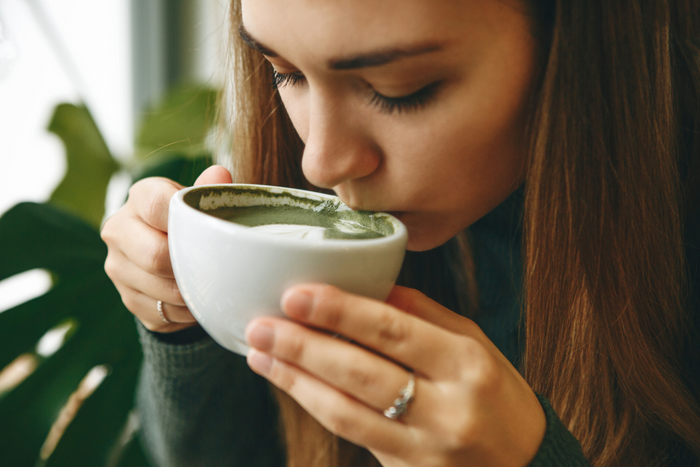 Woman drinking matcha.