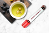 Olive oil with cholesterol blood test tube labeled total and LDL