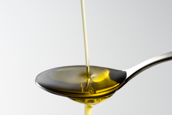 A spoon of olive oil.