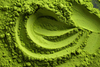 A close-up shot of finely ground matcha powder forming swirling patterns and textures.