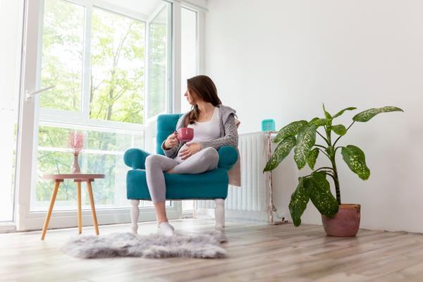 Woman drinking tea while lounging around.