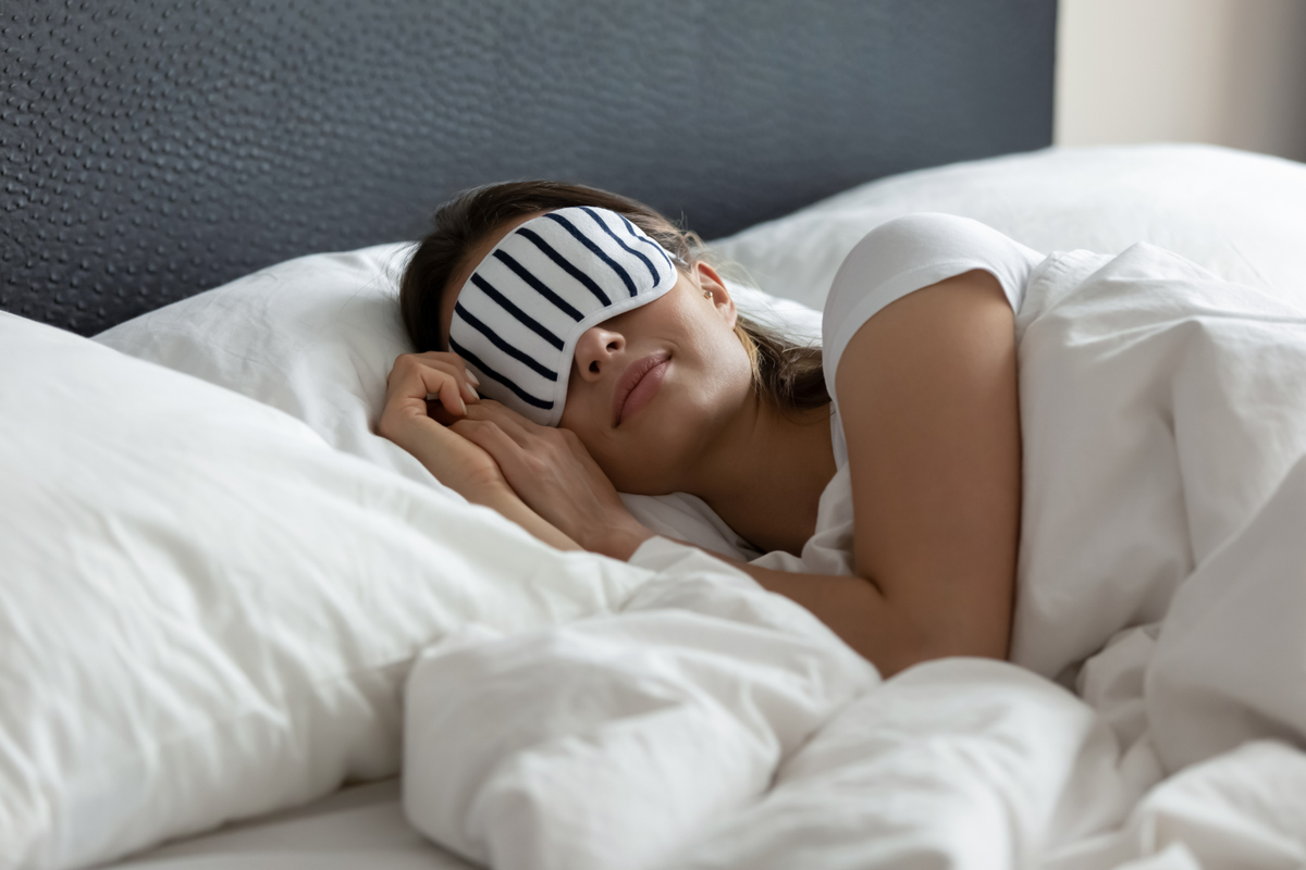 Woman sleeps with an eye mask.