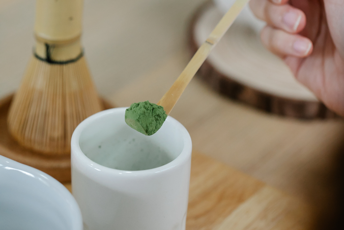 A bamboo scoop of matcha powder.