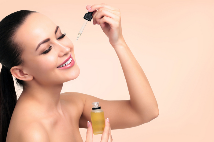 Person applying skincare product on skin.