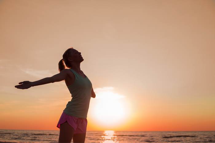 Woman looking healthy with sunset as her background.