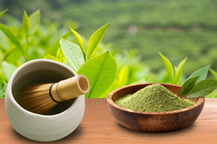 Yame matcha powder with tea leaves and a bamboo whisk, representing Fukuoka’s mountain-grown Japanese matcha.